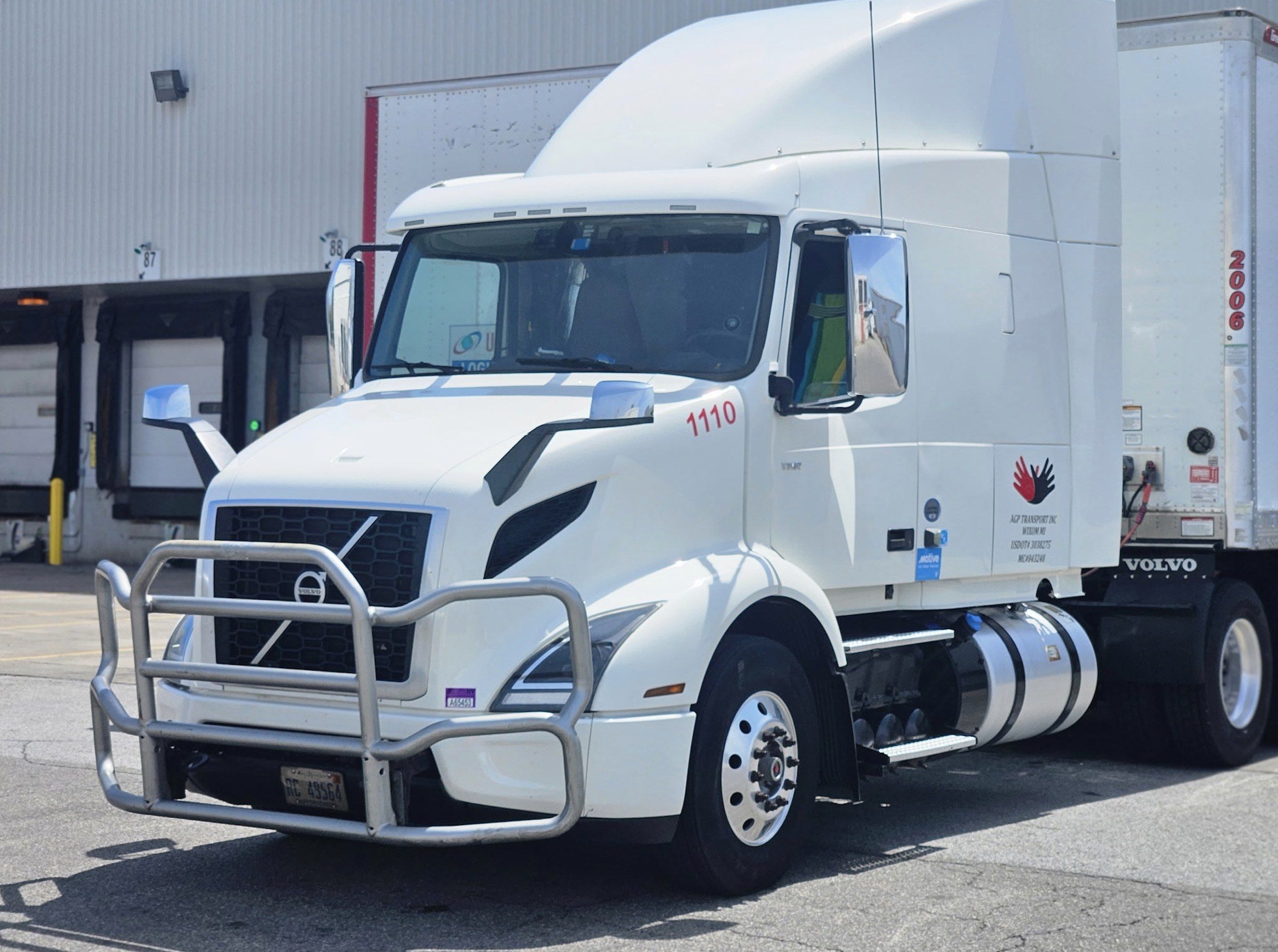 White Volvo tractor, AGP unit 1110, at a loading dock